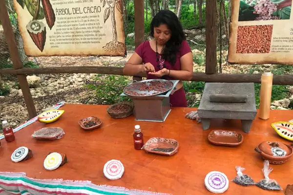 mayan woman grinding cacao