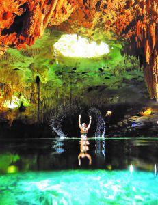 girl swiming in cenote