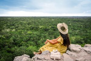 girl looking the jungle from the top of Coba Pyramid