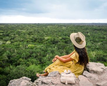 Young Girl watching the horizon in coba ruins