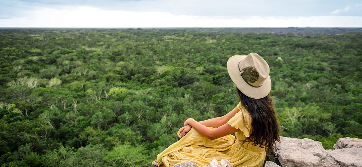 Young Girl watching the horizon in coba ruins