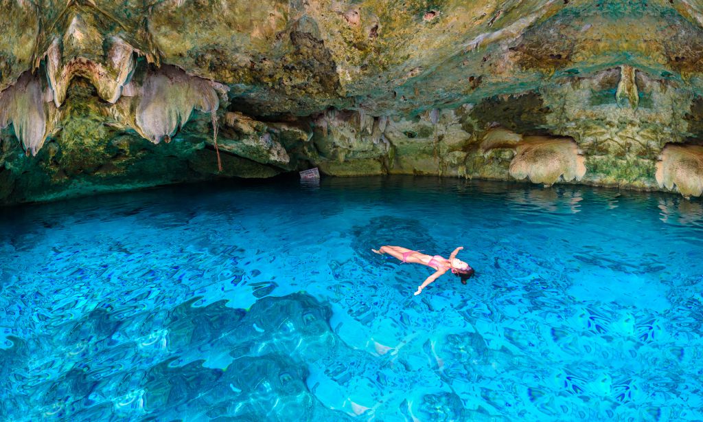 Girl swiming in a cenote