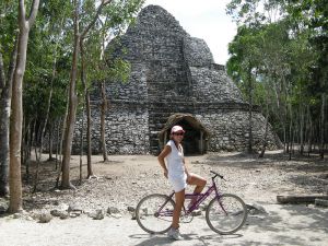 young tourist riding a bicycle in coba