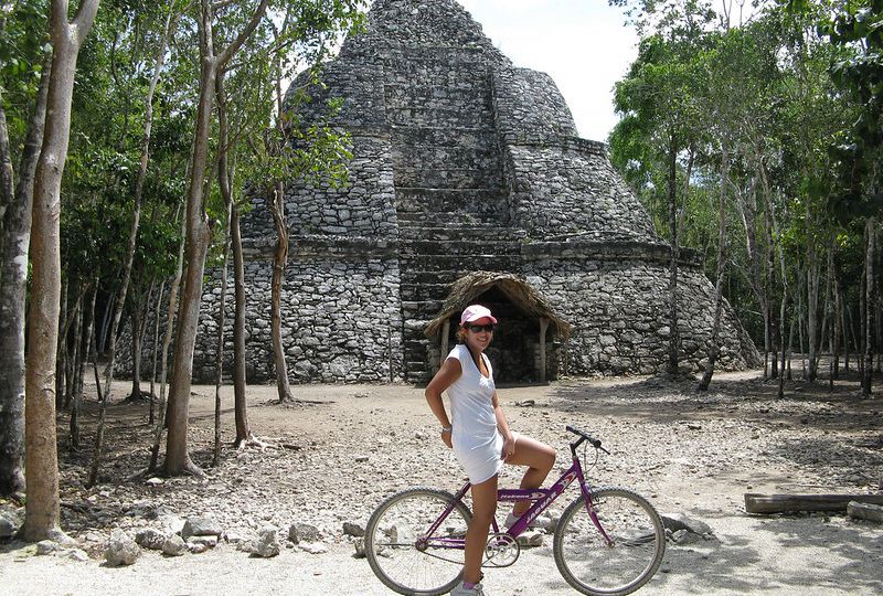 young tourist riding a bicycle in coba